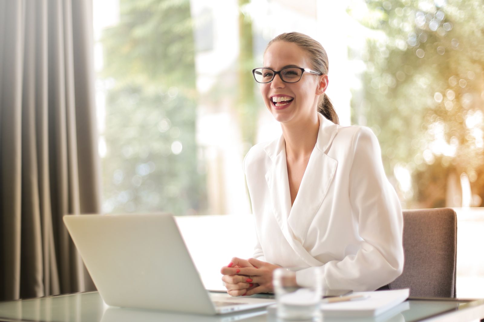 Polished local business owner reviewing brand reputation and AI search narrative on a laptop