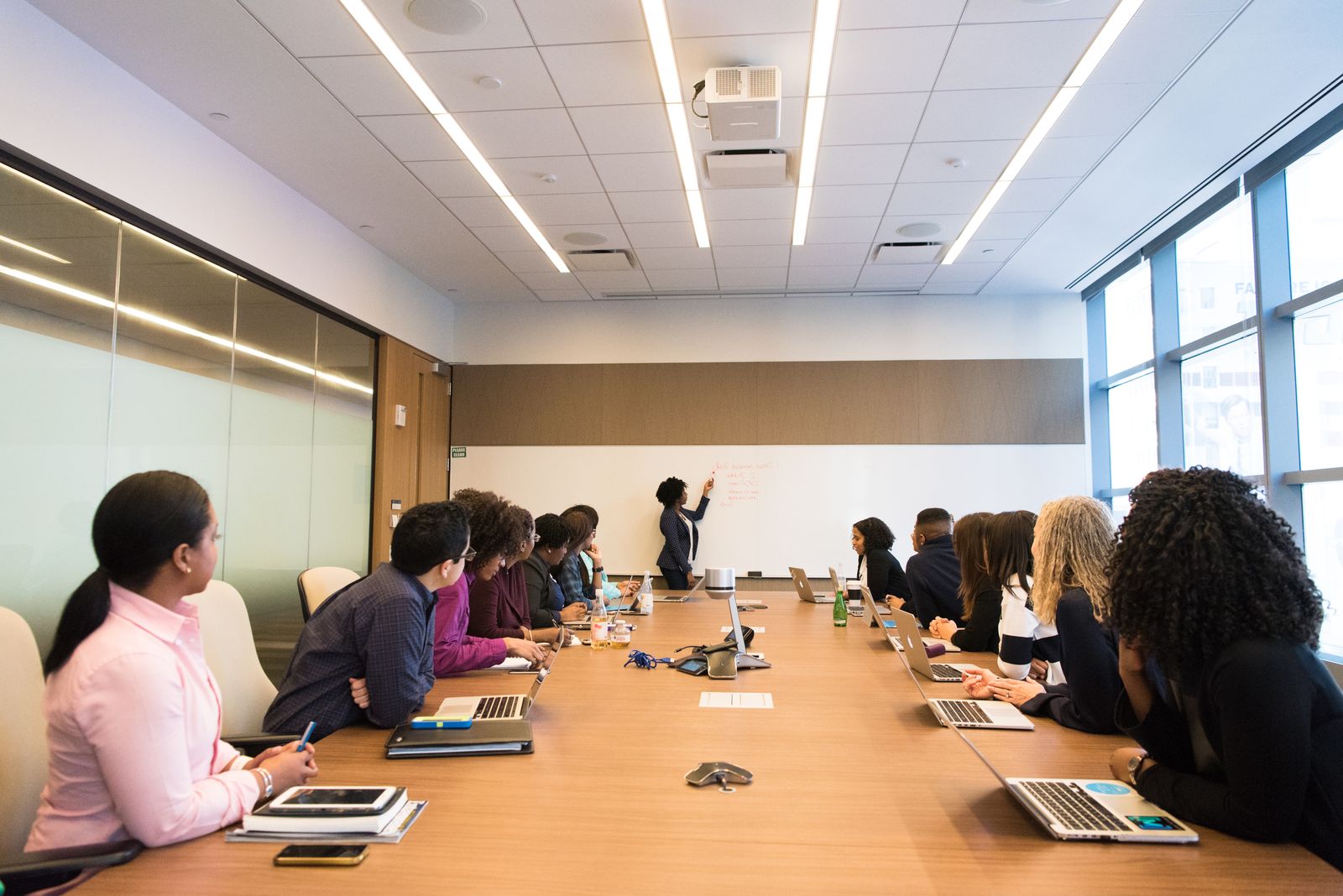 Polished team reviewing a brand narrative briefing in a bright conference room