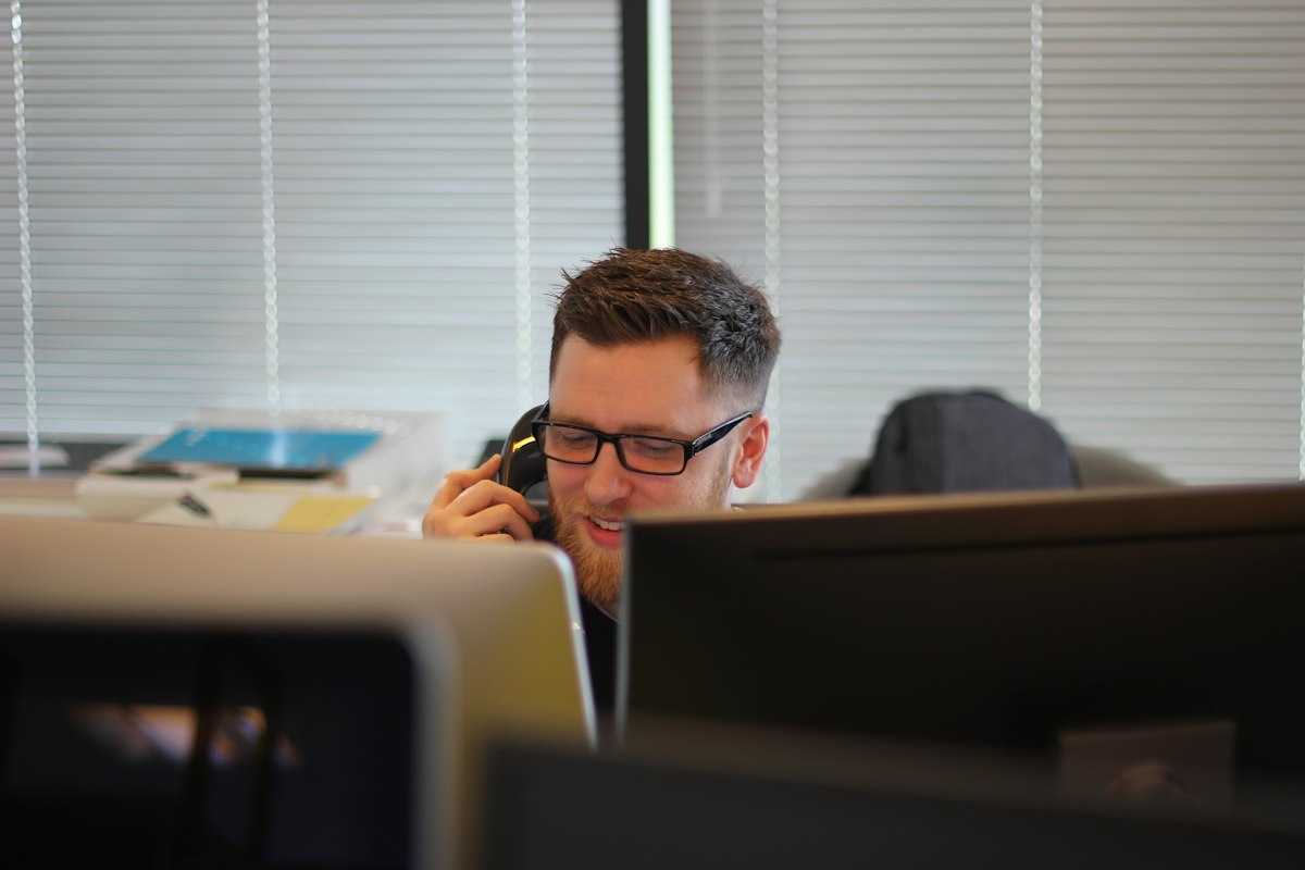 Owner answering high-intent local lead call at desk